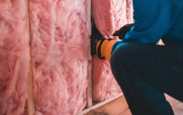 Someone installing wall insulation.